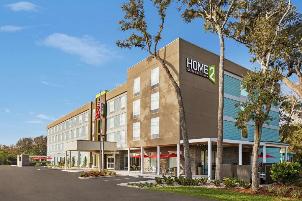 费南迪纳比奇Home2 Suites By Hilton Fernandina Beach on Amelia Island, FL的上面有家庭标志的办公楼