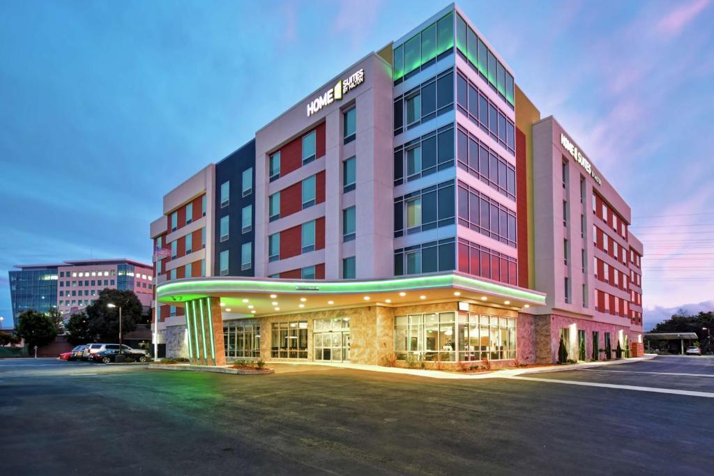 a hotel with a lit up building in a parking lot at Home2 Suites By Hilton San Francisco Airport North in South San Francisco
