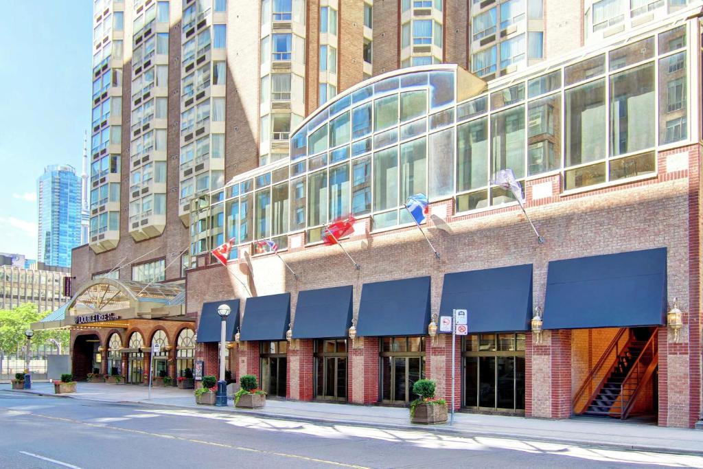 a building with blue awnings on the side of a street at DoubleTree by Hilton Toronto Downtown in Toronto