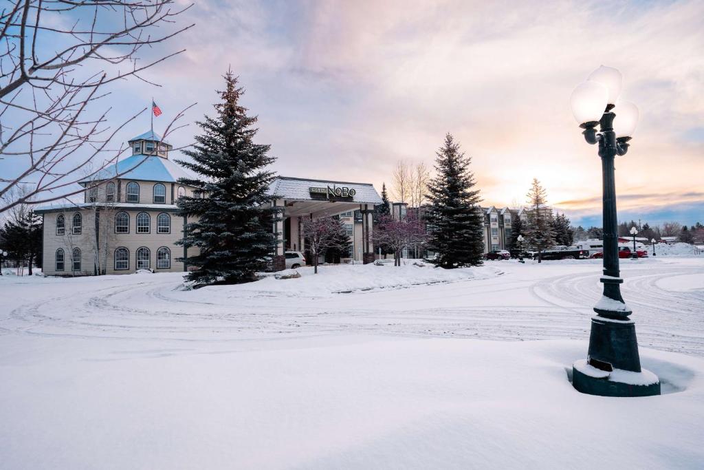 a street light in the snow in front of a building at Hotel NoBo Cascade, Tapestry Collection by Hilton in Cascade