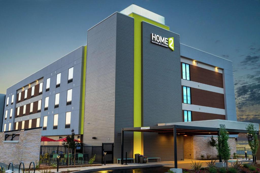 a hotel with a sign on the side of it at Home2 Suites By Hilton Roseville Sacramento in Roseville