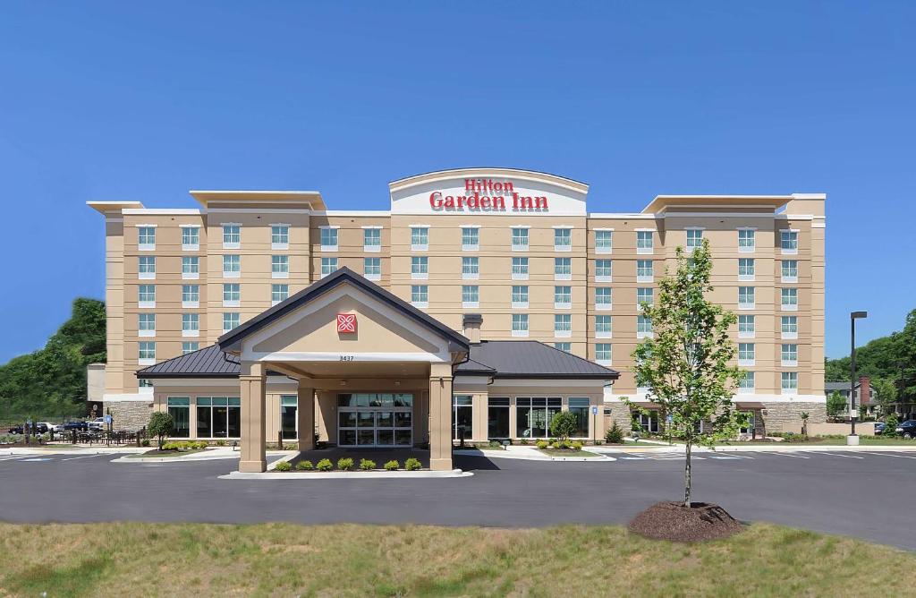 a hotel building with a sign on top of it at Hilton Garden Inn Atlanta Airport North in Atlanta