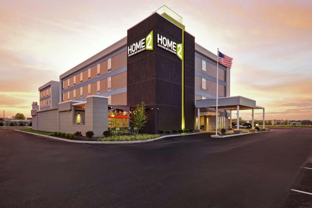 a rendering of a hotel with a large building at Home2 Suites By Hilton Terre Haute in Terre Haute