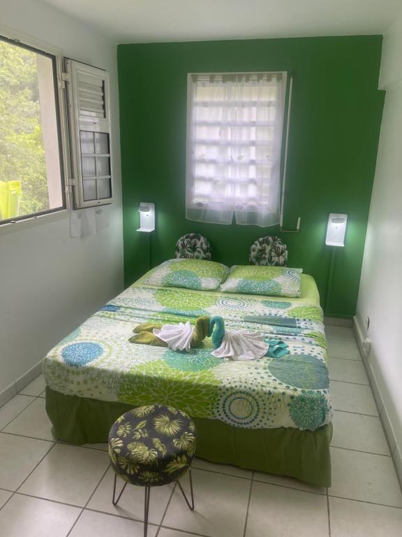 a little girl laying on a bed in a bedroom at La rose in Le Robert