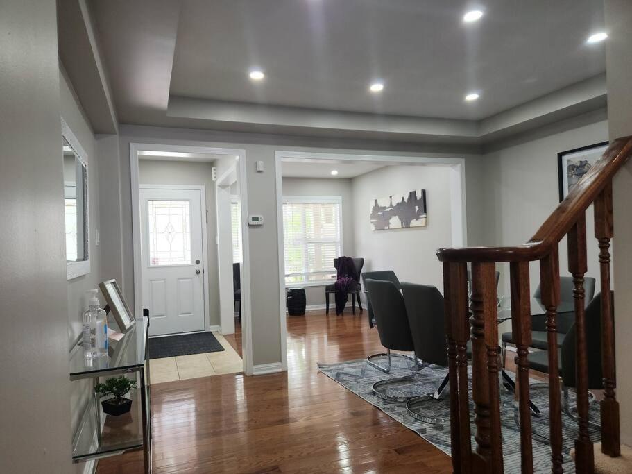 a living room with a staircase and a dining room at Beautiful home away from home in Milton