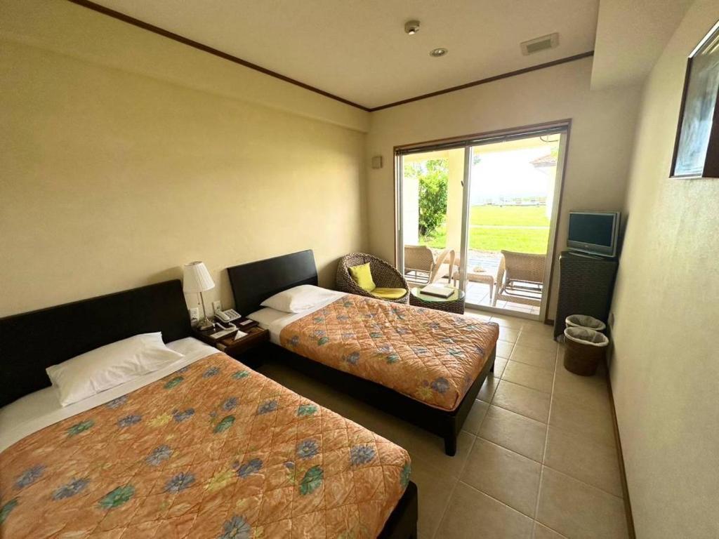 Postel nebo postele na pokoji v ubytování エコヴィレッジ西表 Eco Village Iriomote