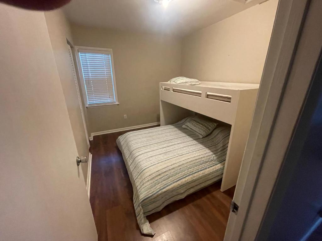 a small bedroom with a bed under a desk at Key West Style Historic Home in Coconut Grove Florida, The Blue House in Miami