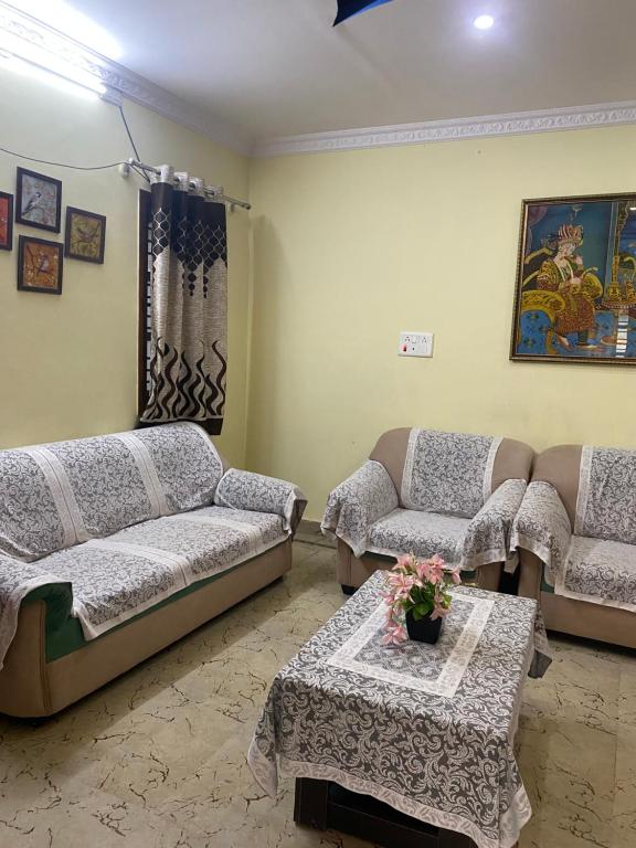 a living room with two couches and a table at Ghar-fully furnished house with 2 Bedroom hall and kitchen in Bangalore