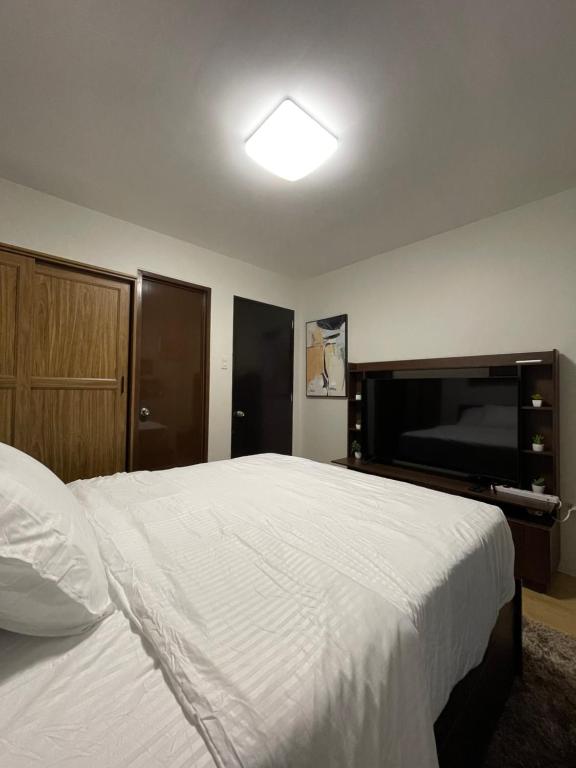 Postel nebo postele na pokoji v ubytování FLY & REST GUESTHOUSE - Mactan-Cebu International Airport