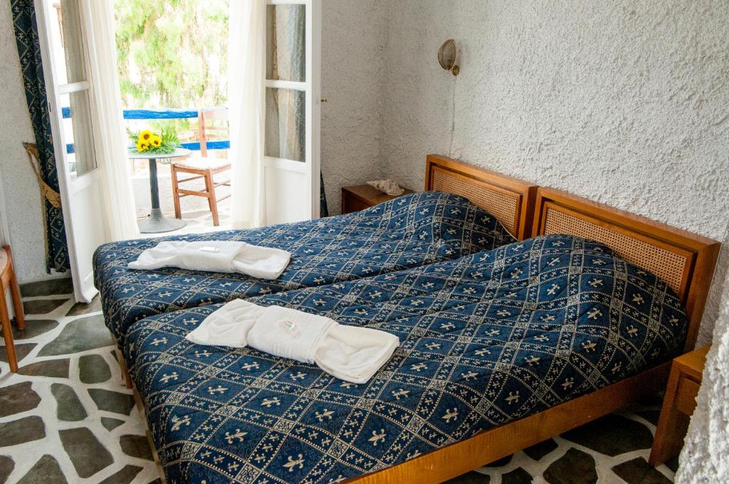 um quarto com duas toalhas numa cama em Manousos' Rooms em Galissas
