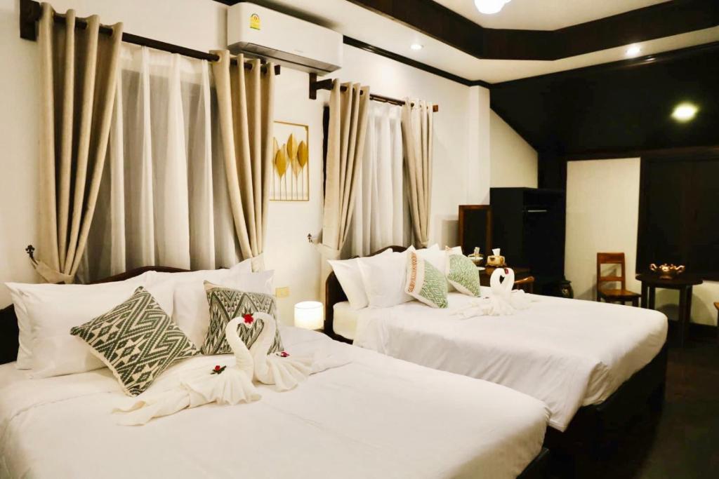 Postel nebo postele na pokoji v ubytování ALOUN Guesthouse