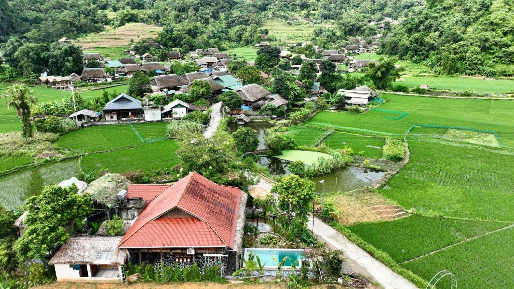an aerial view of a village with a red roof at Thavill Retreat HaGiang in Ha Giang
