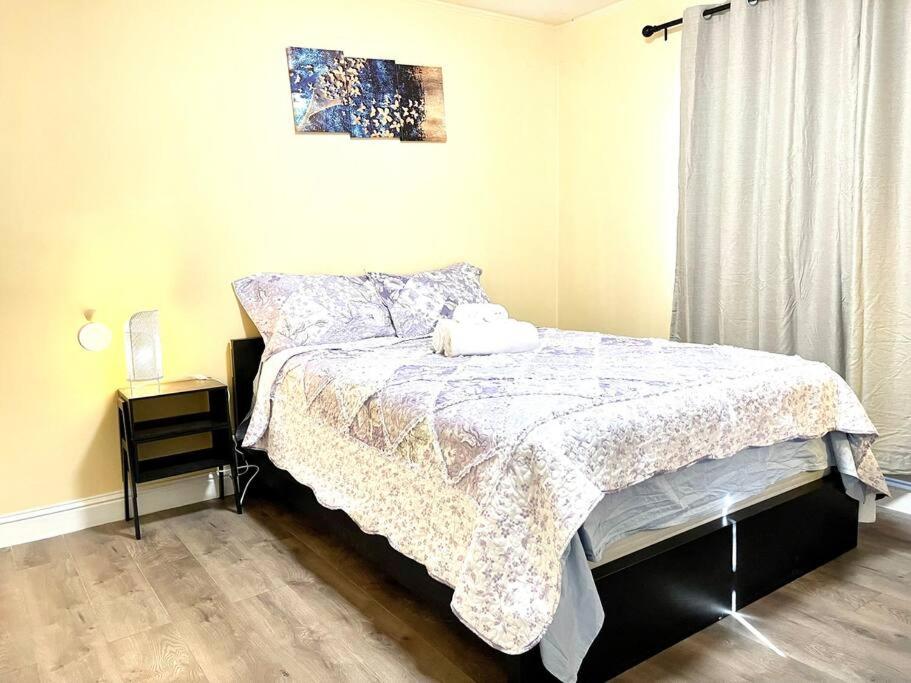 a bedroom with a bed with a blanket and a window at Warm 2BR/1BA house Silicon W/D parkin near SJ town in San Jose