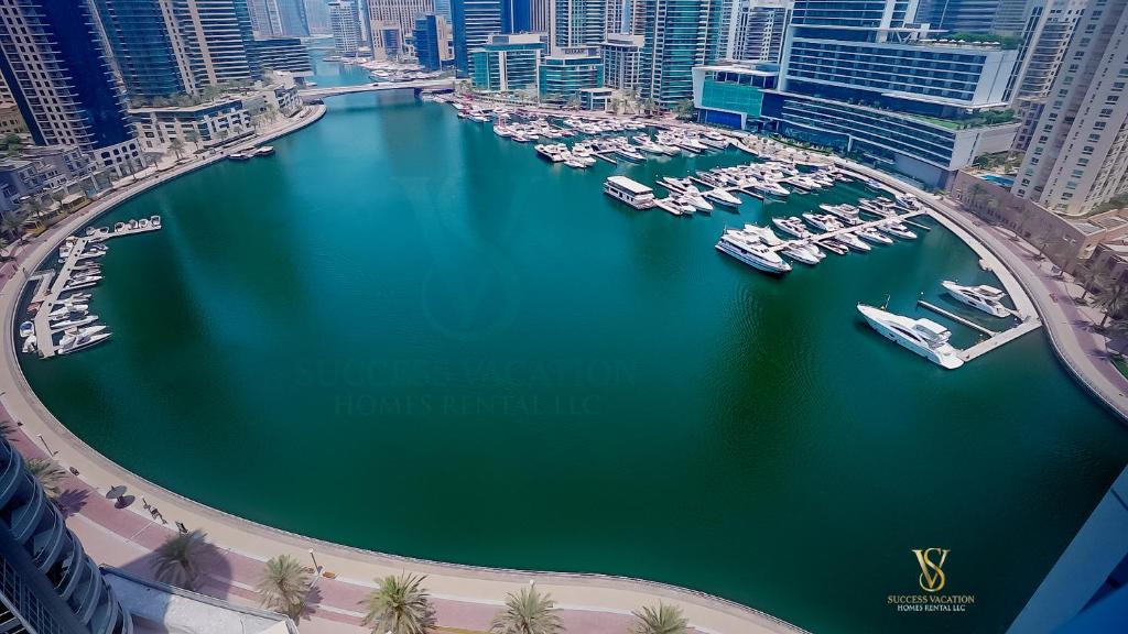 an aerial view of a harbor with boats in the water at Success luxury apartment - 5 min away jbr beach - Free housekeeping provided everyday- 24-7 staff available for services in Dubai