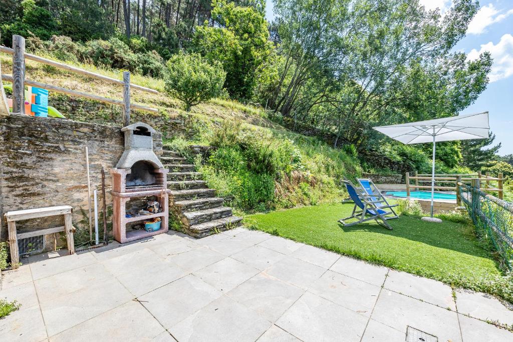 patio z grillem, krzesłem i basenem w obiekcie Casa Davide With Pool - Happy Rentals w mieście Pietrasanta