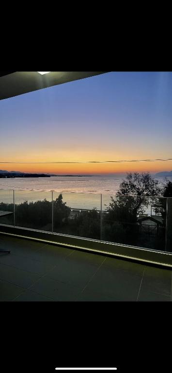a view of the ocean from a tennis court at sunset at Luxury Apartment Sea View Chalkida in Chalkida