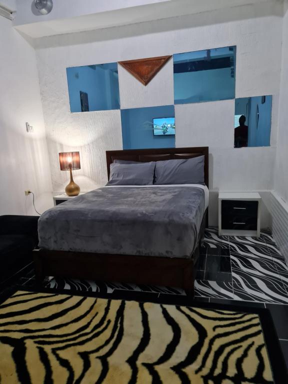 a bedroom with a large bed and a zebra rug at Sky Beach Rooms in Hopewell