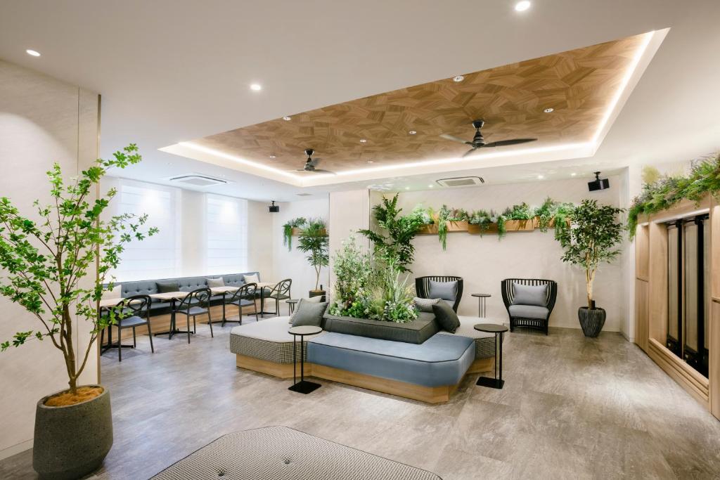 a waiting room with plants on the walls at Tokyu Stay Shibuya in Tokyo