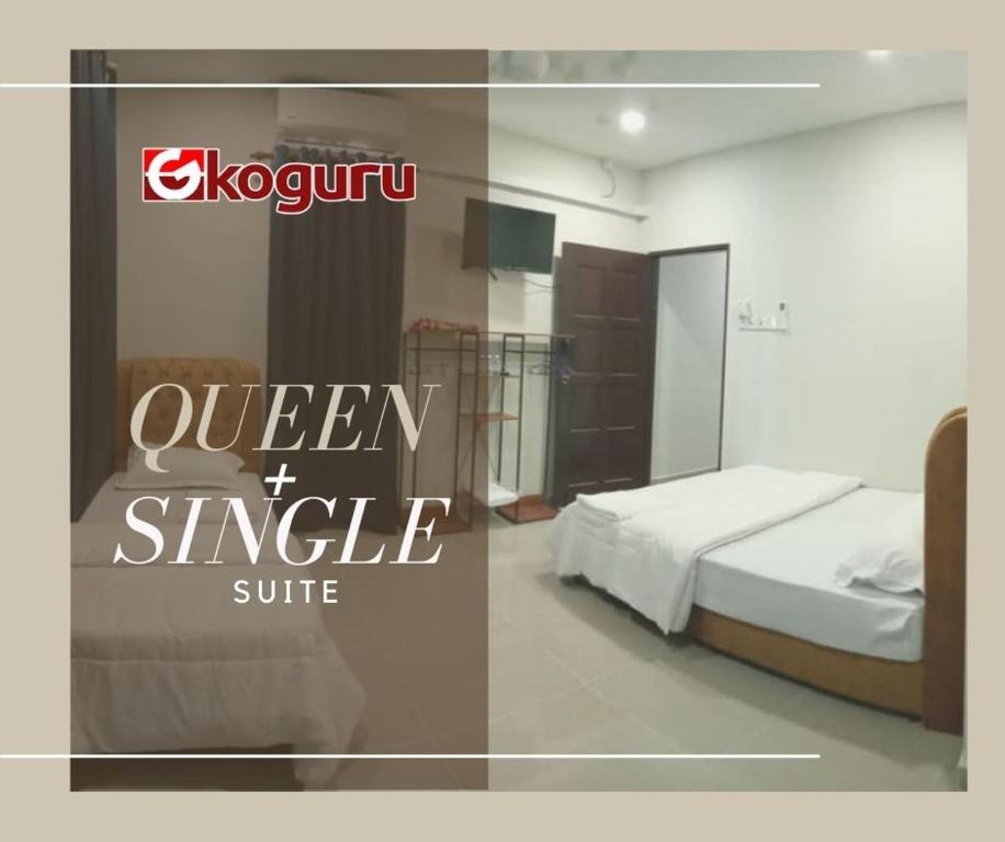 a bedroom with a bed and a sign that reads queen the single suite at TAMU ROOMSTAY TOK MOLOR in Kuala Terengganu