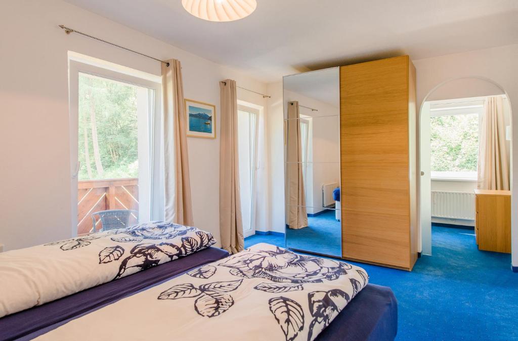 a bedroom with two beds and a mirror at Chalet Vergissmeinnicht in Zell am See