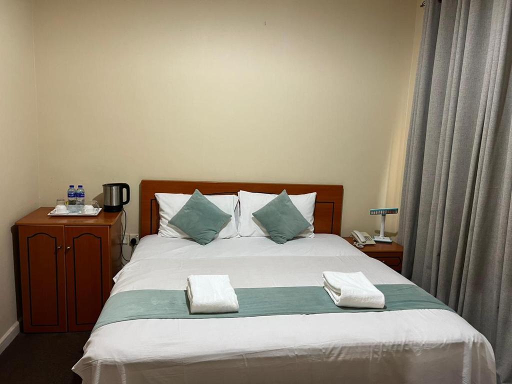 Postel nebo postele na pokoji v ubytování Al Jazeerah Hotel