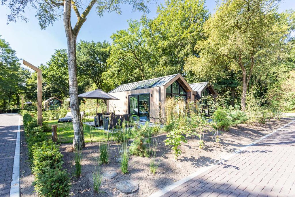 a greenhouse in a garden with plants at TopParken - Résidence Lage Vuursche in Lage-Vuursche