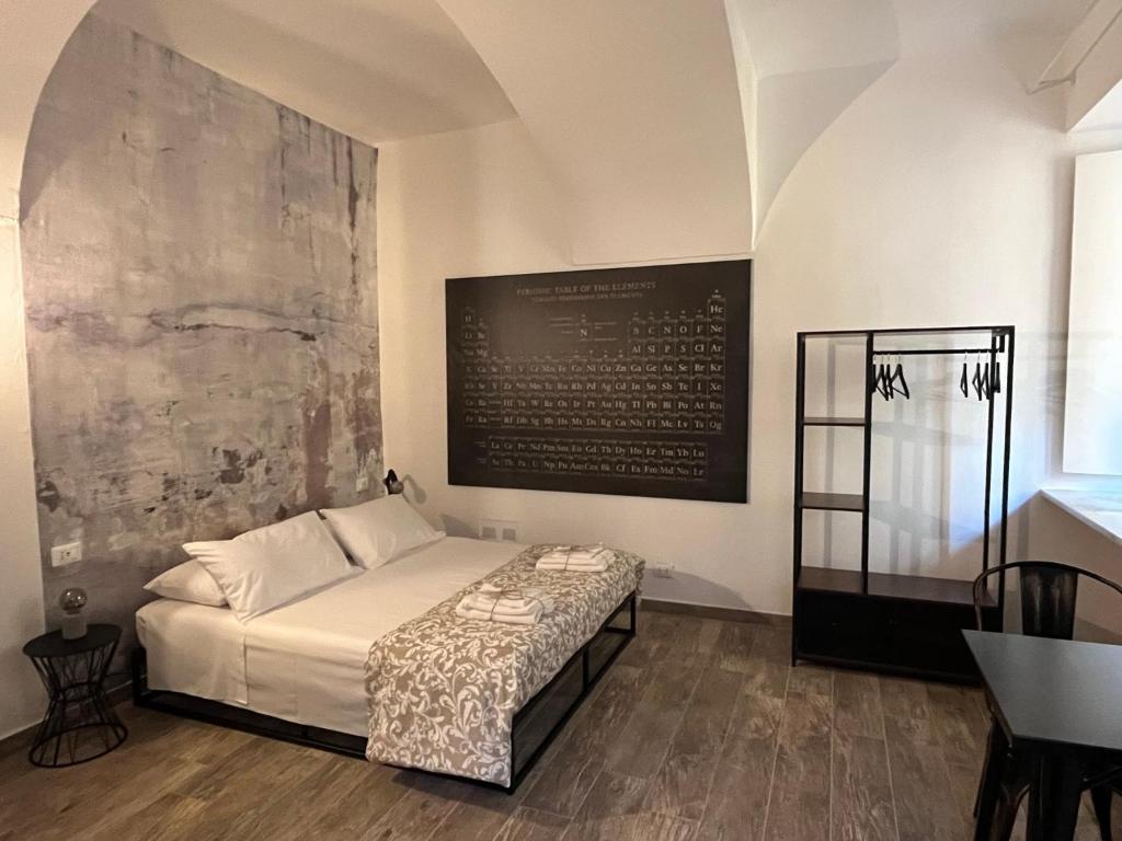 a bedroom with a bed and a large painting on the wall at Chagall Charme in Asti