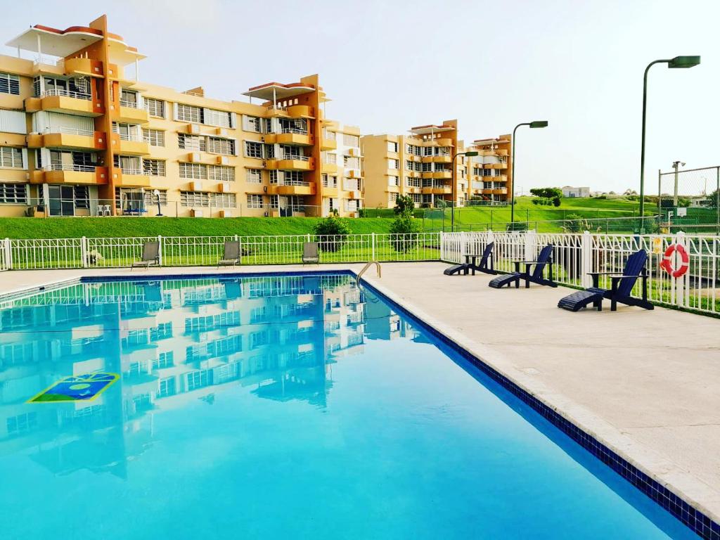 a swimming pool in front of a apartment building at Pearl of the East in Ceiba an entire Penthouse with Ocean View in Santa Maria