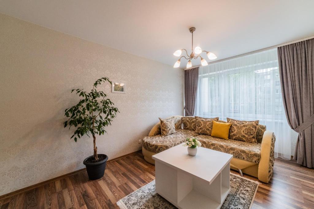 a living room with a couch and a table at A.P. Apartment in Šiauliai