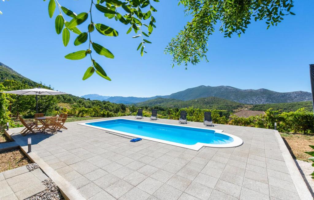 a swimming pool with a view of the mountains at Family House Gata in Gata