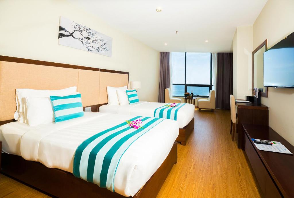 Postel nebo postele na pokoji v ubytování Avatar Danang Hotel