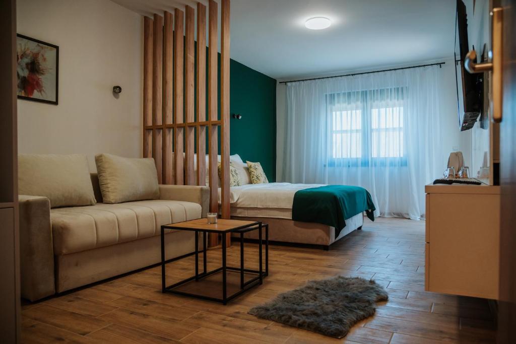 a living room with a couch and a bed at Vila K2 in Vrdnik