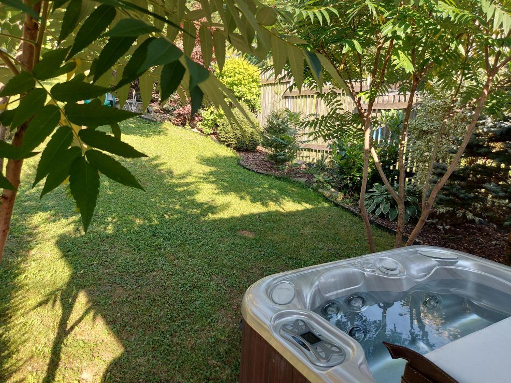 a jacuzzi tub in a yard next to a garden at Chalupa Varechovsky potok in Vysoká nad Kysucou