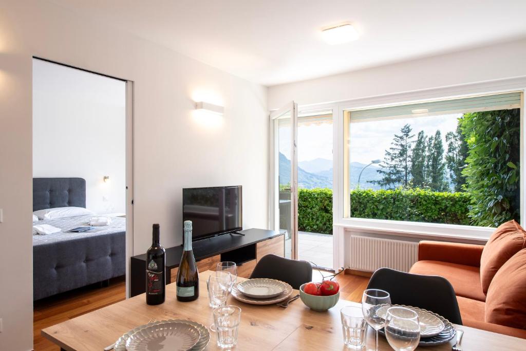 a living room with a couch and a table at Ruvigliana Amazing View - Happy Rentals in Lugano