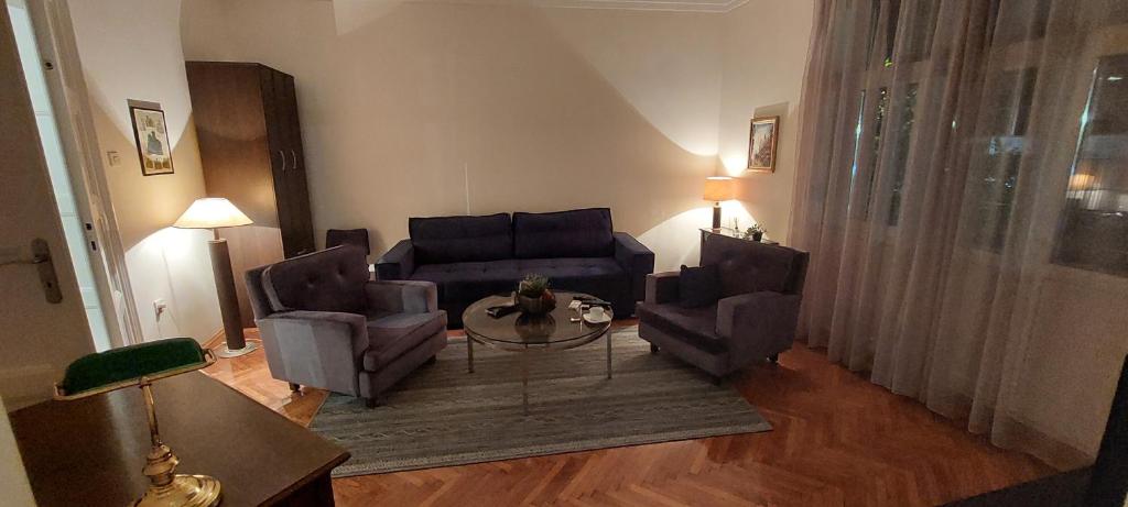 a living room with a couch and two chairs and a table at Bohemian in Belgrade