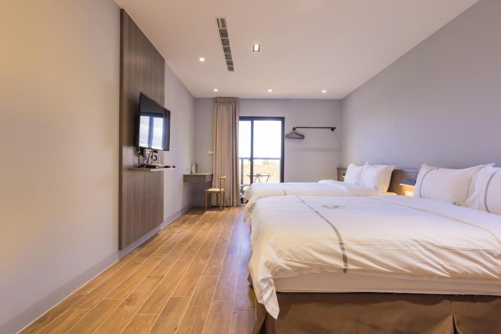 Postel nebo postele na pokoji v ubytování Penghu Swing Sea Homestay