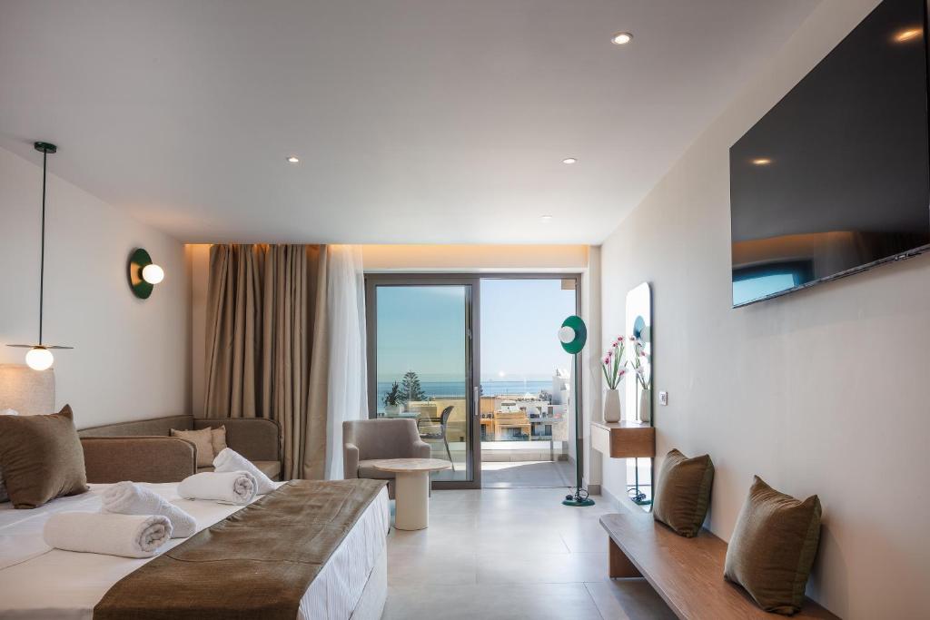 a hotel room with two beds and a view of the ocean at San Antonio Boutique Hotel & Spa - Adults Only in Hersonissos