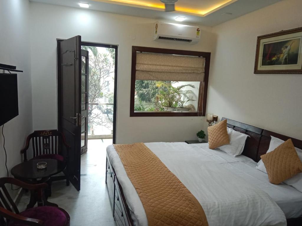 a bedroom with a large bed and a window at Yana's B&B nearby Aiims Hospital in New Delhi