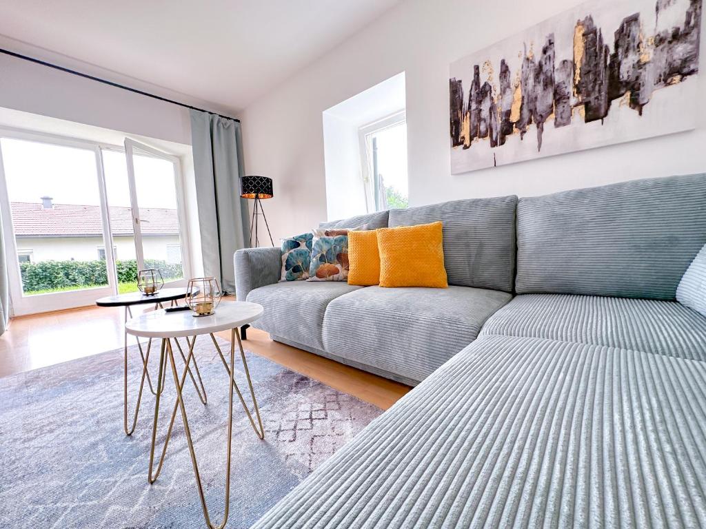 un soggiorno con divano grigio e tavolo di Idyllische Wohnung mit Garten! a Bad Gleichenberg