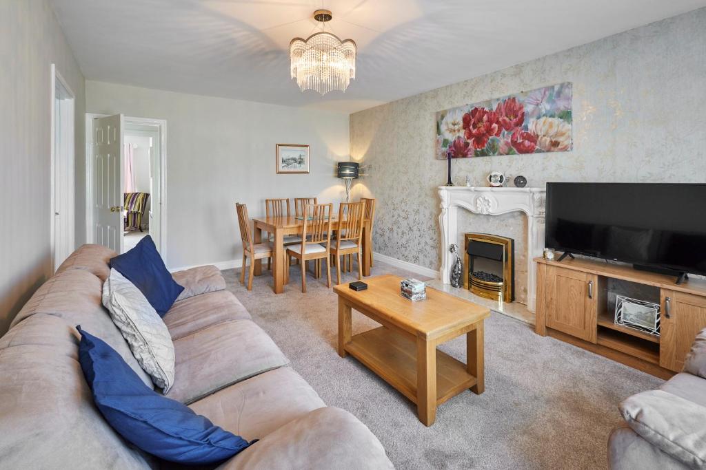 a living room with a couch and a tv and a table at Host & Stay - White Rose in Marske-by-the-Sea