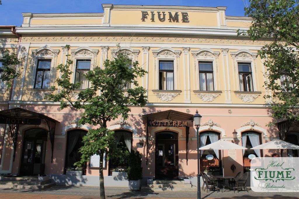 un edificio rosa con un cartel encima en Fiume Hotel, en Békéscsaba