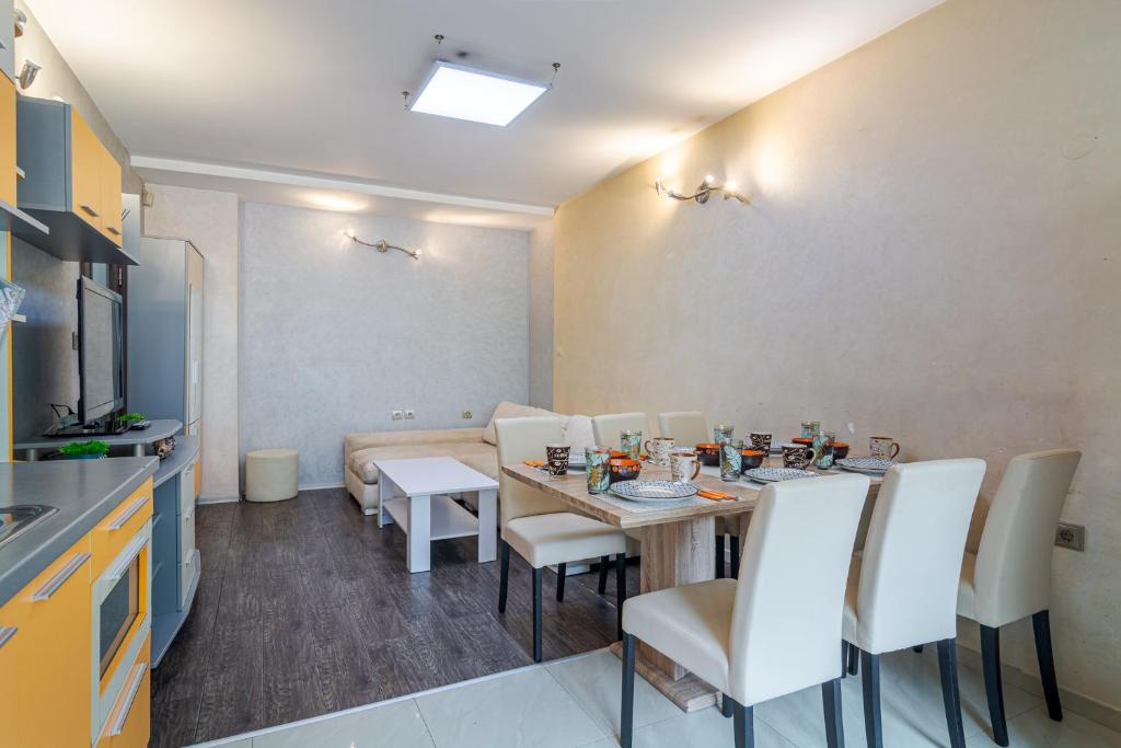 a dining room with a table and white chairs at The Right Choice 1 in Sofia