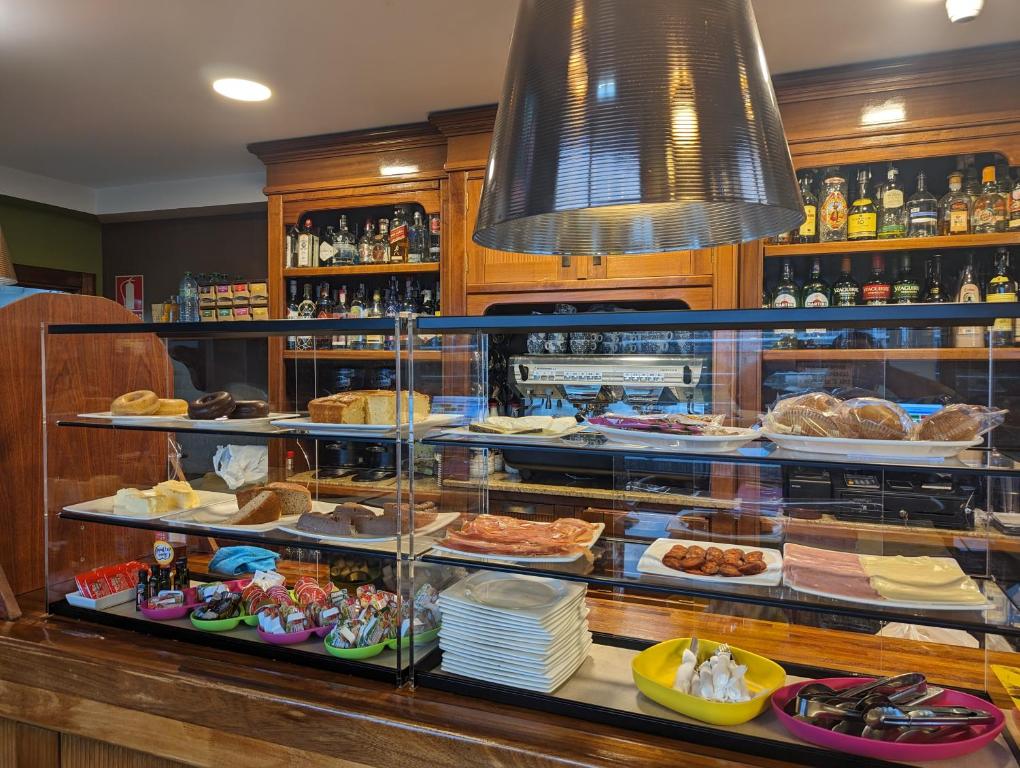 a display case in a restaurant filled with food at La Colina in Gijón