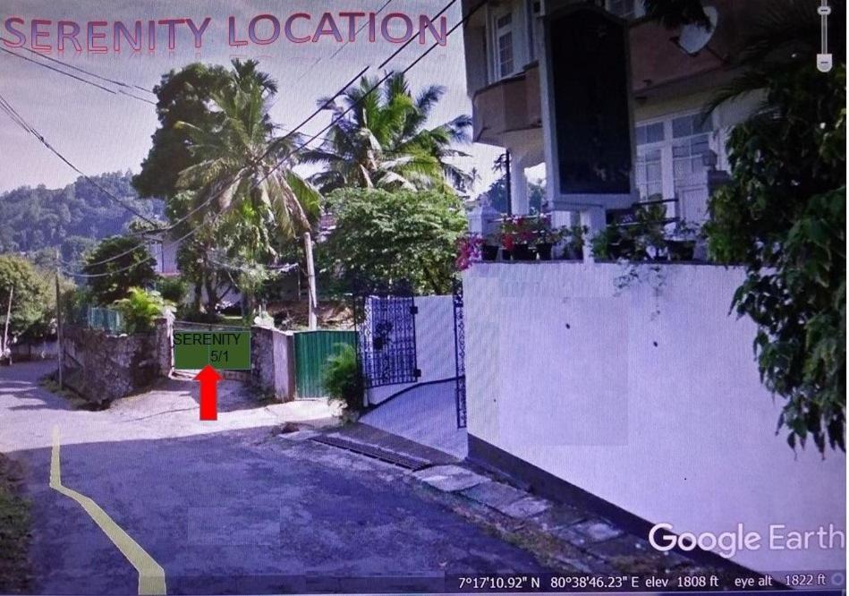 a building with a fence and a red fire hydrant at Serenity in Kandy