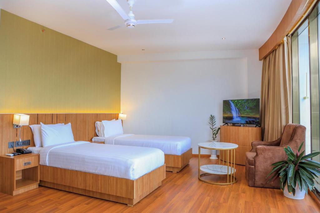 Postel nebo postele na pokoji v ubytování Hotel Sky Sierra Wayanad