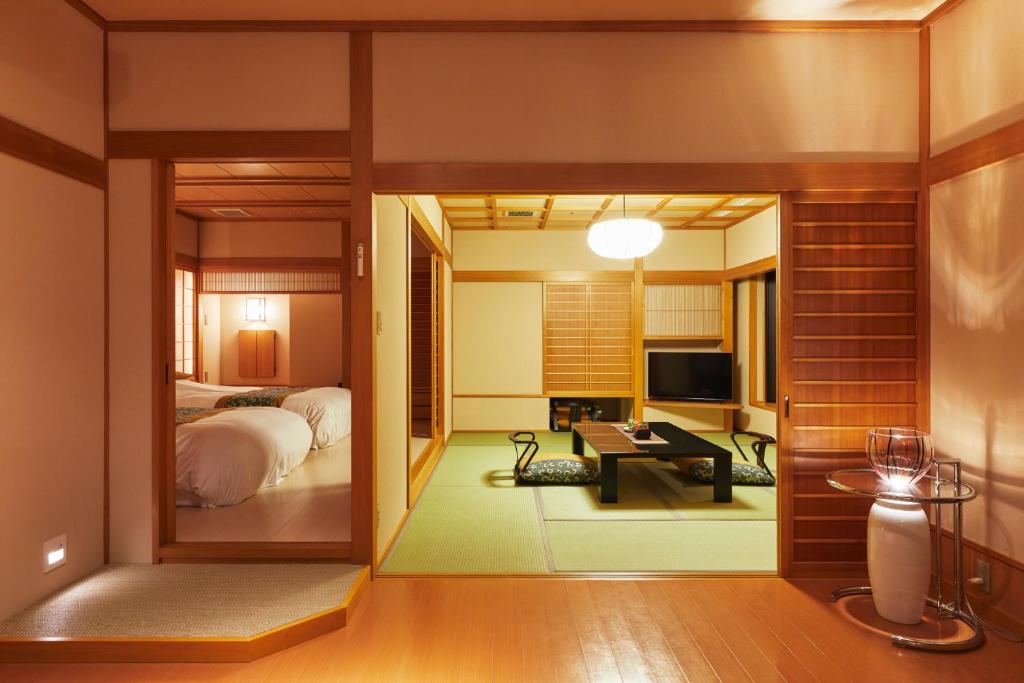 Postel nebo postele na pokoji v ubytování Takinoyu Hotel
