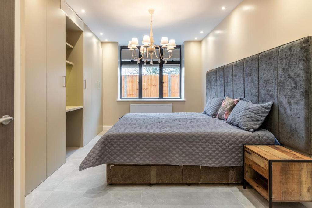 a bedroom with a large bed and a window at Beautiful 1-Bed Apartment in Golders Green London in London