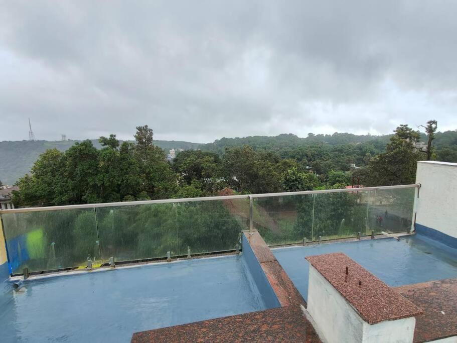 a view of a swimming pool on a balcony at Suite with valley view Panhala Fort in Panhāla