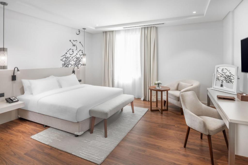 Postel nebo postele na pokoji v ubytování Landmark Hotel & Suites فندق وأجنحة لاندمارك