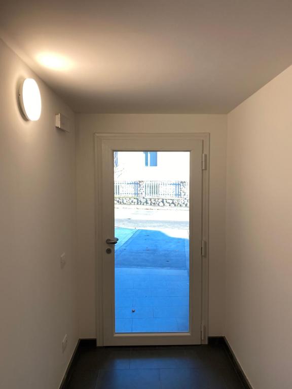 an empty room with a door with a window at Brothers' Suites in Pisogne